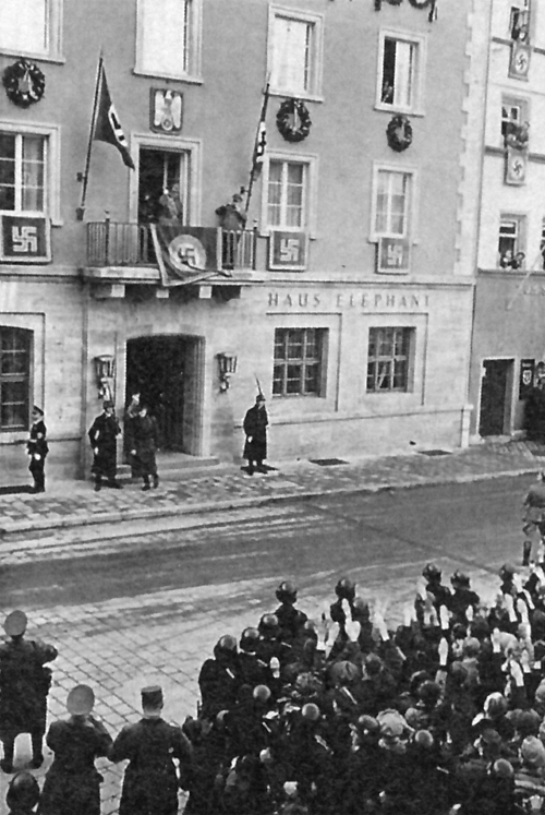 Adolf Hitler salutes the crowd from the balcony of Hotel Haus Elephant in Weimar